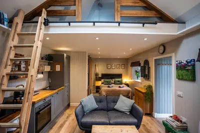 a loft bed in a room with a bedroom at Jura, Mrs Leonard's Cottage in Isle of Jura