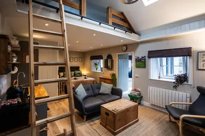 a living room with a loft bed at Jura, Mrs Leonard's Cottage in Isle of Jura