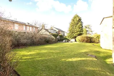a grassy yard with houses and a tree at Beautiful 2 to 3 bed apartment with stunning views! in Ayr