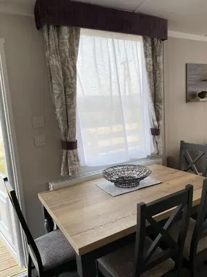 a dining room table with a window and a bowl on it at Swift Bordeaux 67 in Dunoon