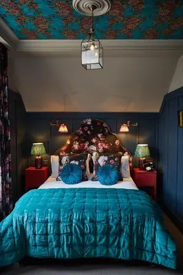 a bedroom with a large bed with blue walls at No17 The Promenade in Oban