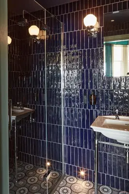 a blue tiled bathroom with a sink and a tub at No17 The Promenade in Oban
