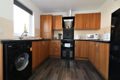 a kitchen with a washer and a washing machine at Signature - Whistleberry House in Hamilton