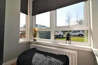 a window seat with a radiator in front of a window at Signature - Whistleberry House in Hamilton