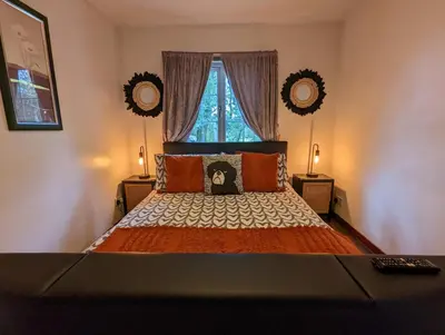 a bedroom with a large bed with a window at Doocot At Bonnyside House - New Hot Tub Aug 2025 in Bonnybridge