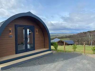 a small circular building with a large door at The Vu Snugs in Bathgate