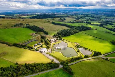 an aerial view of a park with green fields and trees at The Vu Snugs in Bathgate