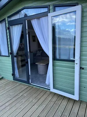 a sliding glass door on a deck at Swift Bordeaux 73 in Dunoon