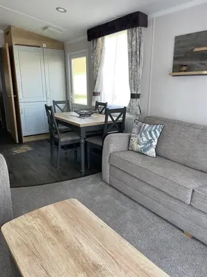 a living room with a couch and a table at Swift Bordeaux 73 in Dunoon