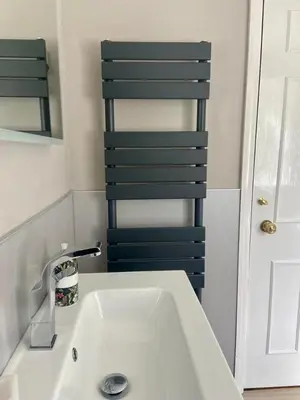 a bathroom with a white sink and a mirror at East Kelt Farm Cottage in Denny