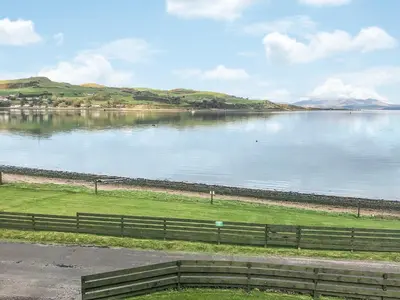 a view of a large body of water with a fence at Gleaner Lea Apartment in Campbeltown