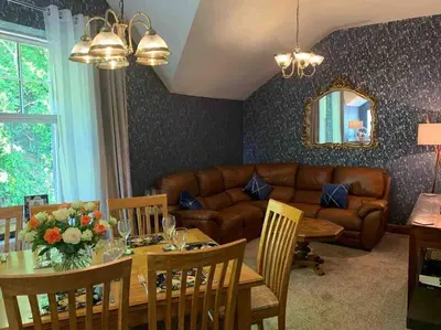 a living room with a table and a couch at The Apartment - Chandlers in Ascog