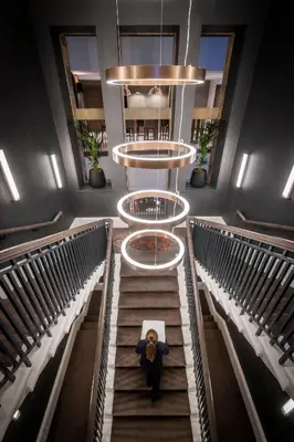 a person walking down a staircase in a building at Clayton Hotel Glasgow City in Glasgow