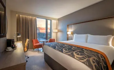 a hotel room with a large bed and a desk at Clayton Hotel Glasgow City in Glasgow