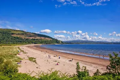a group of people on a beach near the water at Ewe pod, luxury glamping pod with hot tub, Croft4glamping in Benderloch