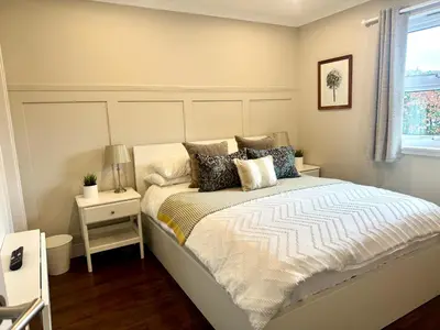 a bedroom with a bed with a night stand and a window at Holly Lodge - 2 x Kingsize bedrooms with private entrance and free parking-new shower room in Oban