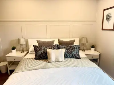 a bedroom with a large bed with pillows at Holly Lodge - 2 x Kingsize bedrooms with private entrance and free parking-new shower room in Oban