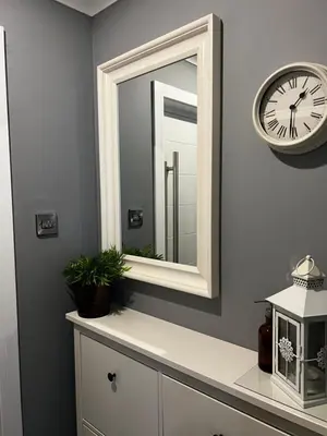 a bathroom with a mirror and a clock on the wall at Holly Lodge - 2 x Kingsize bedrooms with private entrance and free parking-new shower room in Oban