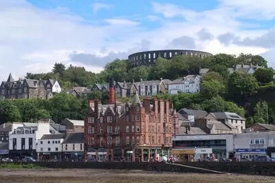 a group of buildings in front of a city at Holly Lodge - 2 x Kingsize bedrooms with private entrance and free parking-new shower room in Oban