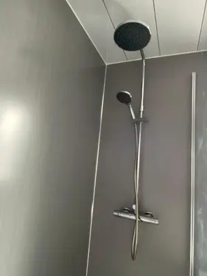 a shower with a shower head in a bathroom at Pure Apartments Fife - Dunfermline West in Oakley