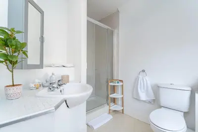 a white bathroom with a toilet and a sink at NEW Four Bedroom House - all rooms ensuite in Stirling