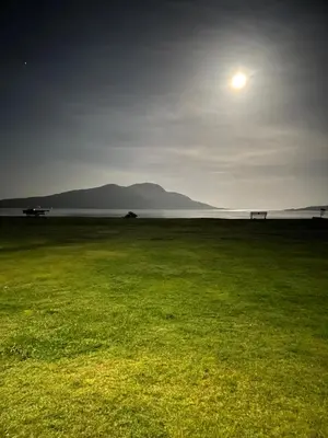 a field of grass with the moon in the sky at Lamlash (holiday) Lets in Lamlash