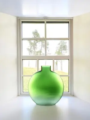 a green vase sitting in front of a window at Stables Cottage in Perth