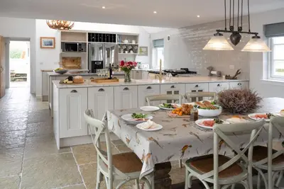 a kitchen with a table with food on it at Laverockbank Farmhouse in Perth