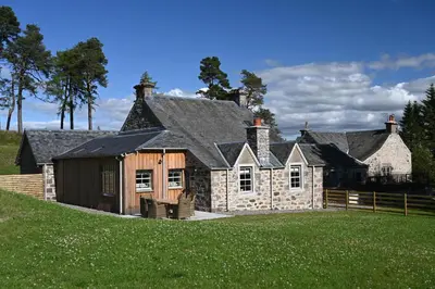 an old stone house on a grassy hill at Coach House in Perth