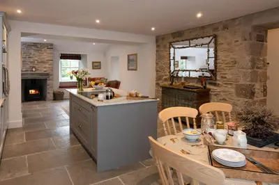 a kitchen and dining room with a table and chairs at Coach House in Perth