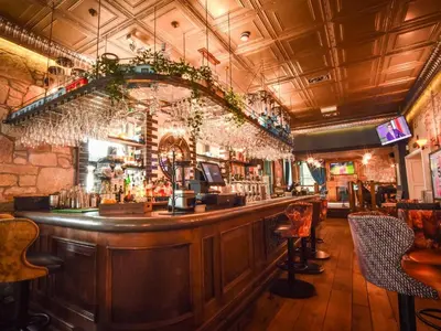 a bar with a wooden counter in a restaurant at The Meadowpark Bar, Kitchen & Rooms in Stirling