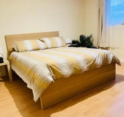a large bed in a bedroom with at Gardiner Cottage in Prestwick