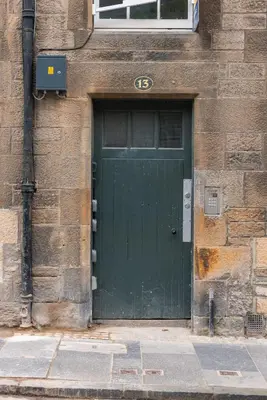 a green door on the side of a building at Charming Grassmarket 1 Bed Castle pad in Edinburgh