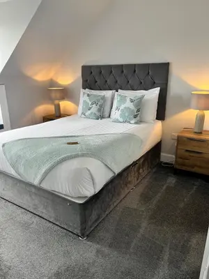 a large bed in a room with two night stands at Killorn Guest House in Oban