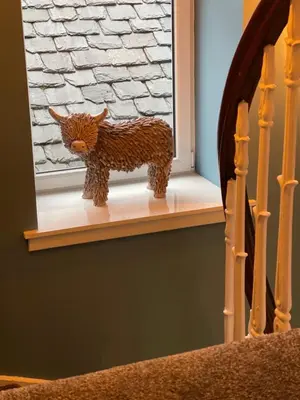 a figurine of a cow sitting on a window sill at Killorn Guest House in Oban