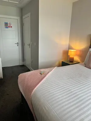 a bedroom with a bed and a lamp on a table at Killorn Guest House in Oban