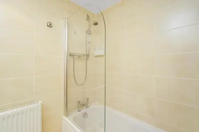a bathroom with a shower and a bath tub at Bell Street Apartments in Glasgow