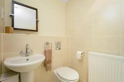 a bathroom with a sink and a toilet and a mirror at Bell Street Apartments in Glasgow