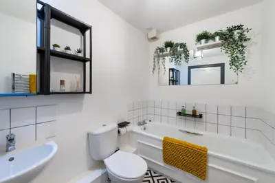 a bathroom with a tub and a toilet and a sink at Lovely 3 bed apartment in central Edinburgh in Edinburgh