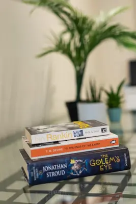 a stack of books sitting on a glass table at Lovely 3 bed apartment in central Edinburgh in Edinburgh