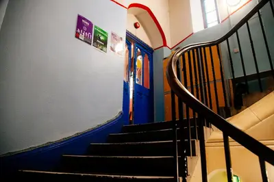 a staircase in a building with a blue door at Belford Hostel in Edinburgh