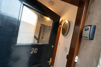 a black door with a window in a room at The Tollbooth in Clackmannan