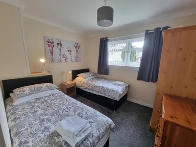 a bedroom with two beds and a window at Hamilton Home From Home in Hamilton
