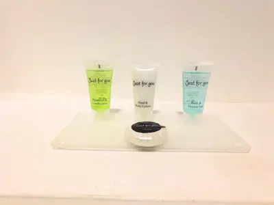 a tray with three bottles of moisturizing cosmetics on it at Newly refurbished 1 bed Apt in Hamilton Close to station and local amenities in Hamilton