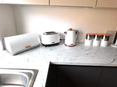 a kitchen counter with various appliances on it at Newly refurbished 2 bedroom apartment close to station and local amenities in Hamilton