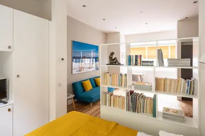 a bedroom with a book shelf filled with books at Artist's Studio in Stockbridge in Edinburgh