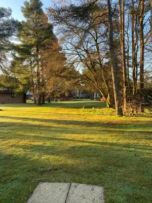 a grassy field with trees in a park at Gleneagles Holiday Home in Auchterarder