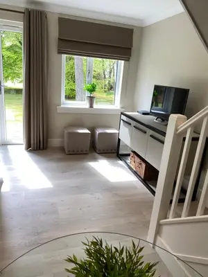 a living room with a desk and a window at Gleneagles Holiday Home in Auchterarder