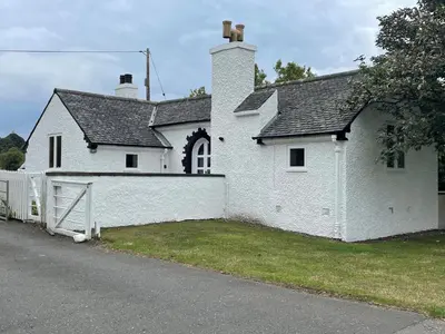 a white house with a fence in front of it at Gate Lodge, House of Binns in Linlithgow
