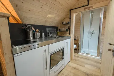 a kitchen with a sink and a stove at 1-Bed Cabin 2 Adults Outdoor Bath & Wood Burner in Carluke